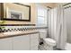 Charming bathroom features a classic black and white tile design and a granite vanity top at 5804 N 9Th St, Tampa, FL 33604