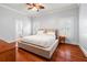 Primary bedroom featuring hardwood floors, ensuite bath, and neutral decor at 5804 N 9Th St, Tampa, FL 33604