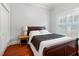 Bedroom with hardwood floors, window with shutters, and closet at 5804 N 9Th St, Tampa, FL 33604