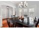 Elegant dining room with hardwood floors, crown molding, and a classic chandelier at 5804 N 9Th St, Tampa, FL 33604