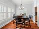 Bright dining room featuring hardwood floors, natural light, and stylish chandelier at 5804 N 9Th St, Tampa, FL 33604