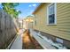 Driveway leading to a detached garage surrounded by a well-maintained yard and fence at 5804 N 9Th St, Tampa, FL 33604
