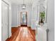 Elegant entryway with hardwood floors, white trim, and a stylish light fixture at 5804 N 9Th St, Tampa, FL 33604