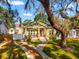 Charming home with a well-manicured lawn, inviting front porch, and mature landscaping at 5804 N 9Th St, Tampa, FL 33604