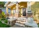 Inviting front porch featuring stone accents, white columns, and a cozy seating area at 5804 N 9Th St, Tampa, FL 33604