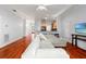 Bright living room with hardwood floors, neutral walls, open floor plan to kitchen at 5804 N 9Th St, Tampa, FL 33604