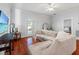 Bright living room with hardwood floors, neutral walls, and view into bedroom at 5804 N 9Th St, Tampa, FL 33604