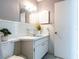 Cozy bathroom featuring a blue sink, well-maintained fixtures, and unique vintage wallpaper at 6251 Danbury St, Spring Hill, FL 34606