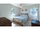Bright bedroom with two windows, ceiling fan and a bed with a seashell themed comforter at 6251 Danbury St, Spring Hill, FL 34606