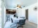 Bright dining area featuring big window, ceiling fan, cozy table and chairs, with access to the kitchen at 6251 Danbury St, Spring Hill, FL 34606
