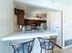 Charming kitchen with breakfast bar, dark wood cabinets and white appliances at 6251 Danbury St, Spring Hill, FL 34606