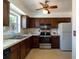 Cozy kitchen with dark wood cabinets, stainless steel appliances and bright natural light at 6251 Danbury St, Spring Hill, FL 34606