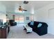 Bright living room with neutral carpet, a ceiling fan, and sliding glass doors leading to the pool area at 6251 Danbury St, Spring Hill, FL 34606