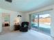 Bright living room with access to pool through sliding glass door, plus a comfortable recliner and side table at 6251 Danbury St, Spring Hill, FL 34606