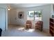 Bright living room featuring neutral carpet, a large window with natural light, and comfortable seating at 6251 Danbury St, Spring Hill, FL 34606