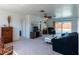 Bright living room with neutral carpet, a ceiling fan, and sliding glass doors leading to the pool area at 6251 Danbury St, Spring Hill, FL 34606