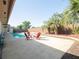Relaxing pool area with patio, chairs, palm trees and privacy fence perfect for outdoor enjoyment at 6251 Danbury St, Spring Hill, FL 34606