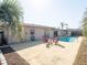 Backyard pool and patio area with outdoor seating and lush palm trees at 6251 Danbury St, Spring Hill, FL 34606
