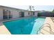 Inviting pool with ladder, neutral surround, and plenty of space to relax and enjoy the outdoors at 6251 Danbury St, Spring Hill, FL 34606