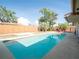 Backyard pool with clear blue water, surrounded by palm trees and a wooden fence at 6251 Danbury St, Spring Hill, FL 34606