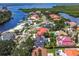 Aerial view of a waterfront residential neighborhood showcasing lush landscaping, mature trees, and water views at 7108 Pelican Island Dr, Tampa, FL 33634