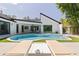 Serene backyard featuring a modern pool, lush landscaping, and a stylish patio with comfortable lounge seating at 7108 Pelican Island Dr, Tampa, FL 33634