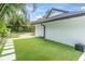 Expansive backyard featuring well-manicured artificial turf and modern landscaping, perfect for outdoor living at 7108 Pelican Island Dr, Tampa, FL 33634