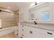 Stylish bathroom featuring granite counters, modern fixtures, and wood-look tile in the shower and on the floors at 7108 Pelican Island Dr, Tampa, FL 33634
