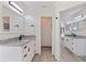 Bathroom featuring granite countertops with double sinks, white cabinets, and modern fixtures at 7108 Pelican Island Dr, Tampa, FL 33634