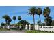 Elegant entrance to Pelican Island, a deed restricted community, with lush palm trees and well-maintained landscaping at 7108 Pelican Island Dr, Tampa, FL 33634