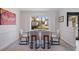 Chic dining space with a glass-top table, comfortable seating, and a large window offering a view of the outdoors at 7108 Pelican Island Dr, Tampa, FL 33634
