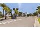 Gated entrance to a residential community with mature trees and a well maintained landscaped median at 7108 Pelican Island Dr, Tampa, FL 33634