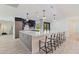 Modern kitchen featuring a large island with bar seating and stylish pendant lighting at 7108 Pelican Island Dr, Tampa, FL 33634