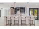 Spacious kitchen featuring an oversized island with barstool seating and modern light fixtures at 7108 Pelican Island Dr, Tampa, FL 33634