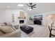 Bright living room with a stone fireplace, high ceilings, and a ceiling fan at 7108 Pelican Island Dr, Tampa, FL 33634