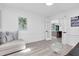 Bright living room with elegant decor, light-colored walls, and French doors leading to kitchen at 7108 Pelican Island Dr, Tampa, FL 33634