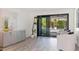 Bright living room with stylish furnishings, a modern cabinet, and a large sliding door leading to the pool area at 7108 Pelican Island Dr, Tampa, FL 33634