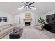 Bright living room with a stone fireplace, vaulted ceilings, and modern decor at 7108 Pelican Island Dr, Tampa, FL 33634