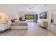 Comfortable main bedroom with modern decor, a ceiling fan, and sliding glass doors to the pool area at 7108 Pelican Island Dr, Tampa, FL 33634