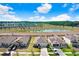 Aerial view of a residential neighborhood with a scenic pond and convenient highway access at 7929 Sail Clover Ln, Zephyrhills, FL 33540