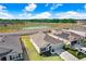 An aerial view of a house with a pond nearby in a Gathering-friendly neighborhood at 7929 Sail Clover Ln, Zephyrhills, FL 33540