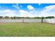 Spacious backyard with healthy green grass and white vinyl fencing at 7929 Sail Clover Ln, Zephyrhills, FL 33540