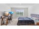 A bedroom showcases a comfortable bed, workspace, and window, creating a relaxing retreat at 7929 Sail Clover Ln, Zephyrhills, FL 33540