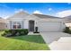 Charming single-story home with manicured lawn, gray siding, and a two-car garage at 7929 Sail Clover Ln, Zephyrhills, FL 33540