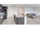 Spacious kitchen area, featuring an island, stainless steel appliances, and sleek modern finishes at 7929 Sail Clover Ln, Zephyrhills, FL 33540