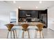 A kitchen island boasts barstool seating, granite countertops, stainless steel appliances, and a modern backsplash at 7929 Sail Clover Ln, Zephyrhills, FL 33540
