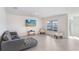 Bright and airy living room with a comfortable sofa, decorative seating, and tile floors at 7929 Sail Clover Ln, Zephyrhills, FL 33540
