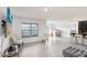 Spacious open floor plan features tile flooring, large windows, and a bar with seating at 7929 Sail Clover Ln, Zephyrhills, FL 33540
