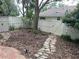 Backyard featuring stone walkways, lush greenery, and a privacy fence at 826 Glades Ne Ct, St Petersburg, FL 33702