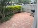Brick paved backyard featuring lush greenery, a privacy fence, and barbecue grill at 826 Glades Ne Ct, St Petersburg, FL 33702